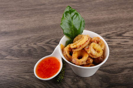 Fried squid rings with hot spicy sauceの写真素材
