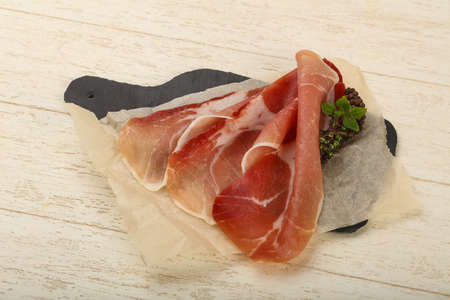 Spanish hamon ready for eat ovet the wooden backgroundの写真素材
