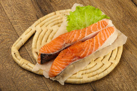 Raw salmon slice ready for baking with spicesの写真素材