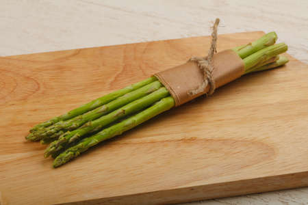 Green asparagus heap on the wood backgoundの写真素材