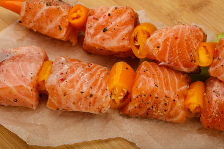 Raw salmon skewer with spices ready for cookingの写真素材