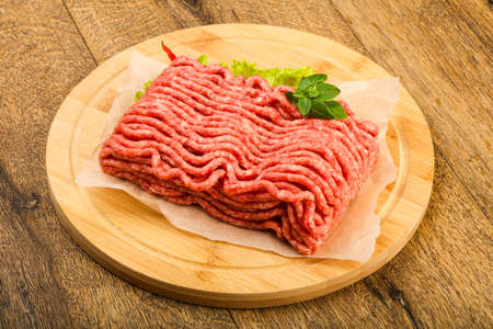 Minced beef meat with basil leaves ready for cookingの写真素材