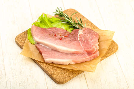 Raw pork steak with pepper and spicesの写真素材
