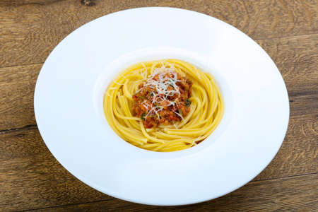 Spaghetti bolognese with parmesan and basil leavesの写真素材