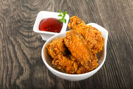 Crispy chicken wings with  ketchupの写真素材