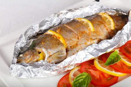 Roasted trout with tomato and lemonの写真素材