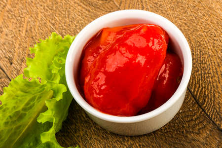 Peeled tomatoes with juice in the bowlの写真素材