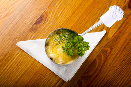 Mushroom cocotte with cheese and herbsの写真素材