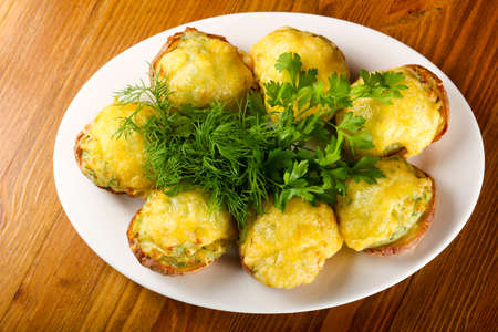 Baked potato with cheese and herbsの写真素材