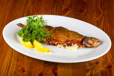 Trout stuffed cheese served lemon and herbsの写真素材