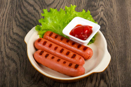 Grilled sausages with salad and ketchupの写真素材