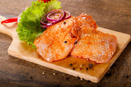 Raw marinated chicken thighs for grill and bbqの写真素材