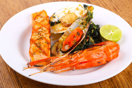 Grilled seafood mix with salmon, waterprawn, mussel and scallopの写真素材