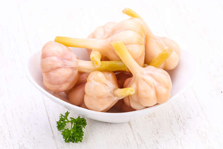 Tasty pickled garlic in the bowlの写真素材