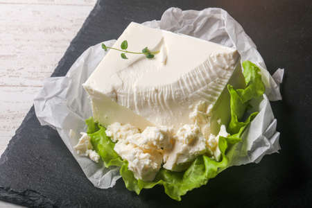 Greek feta cheese with salad leaves and thyme branch