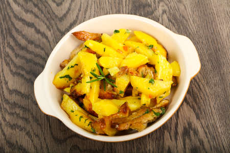 Fried potato with pork served rosemary