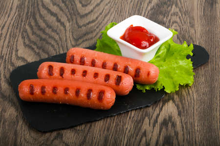 Grilled sausages with salad and ketchupの写真素材