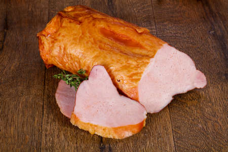 Smoked pork meat over the wooden backgroundの写真素材