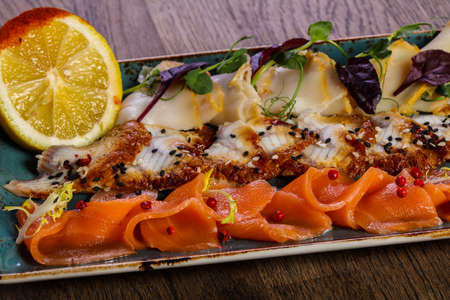 Sliced fish plate served lemonの写真素材