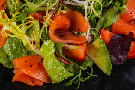 Salad with salmon and avocado with nut sauceの写真素材