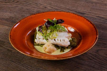 Steamed fish with salad leaves