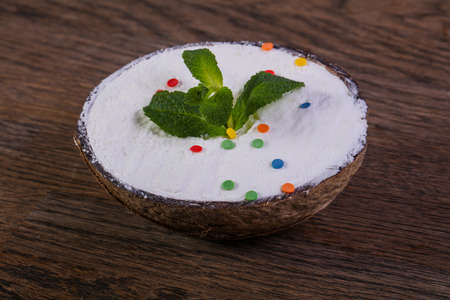 Ice-cream in cocoa nut with mintの写真素材