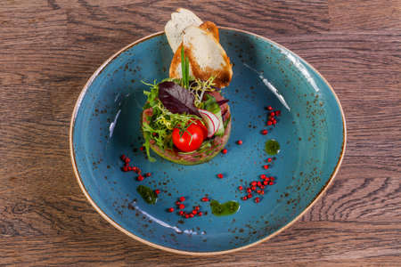 Tartar with salmon and avocado served vegetablesの写真素材