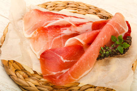 Spanish hamon ready for eat ovet the wooden backgroundの写真素材