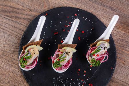 Herring snack wirh onion and breadの写真素材