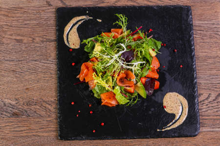 Salad with salmon and avocado with nut sauce