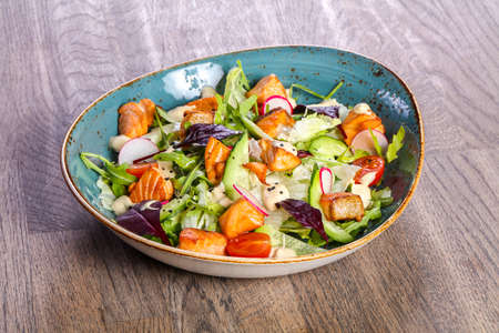 Salad with grilled salmon and cucumbersの写真素材