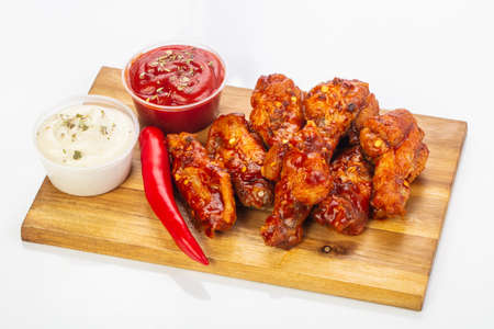 Buffalo chicken wings with sauce and pepperの写真素材