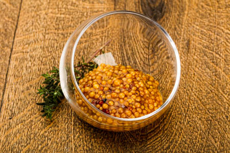 Dijon mustard sauce in the bowl served thymeの写真素材