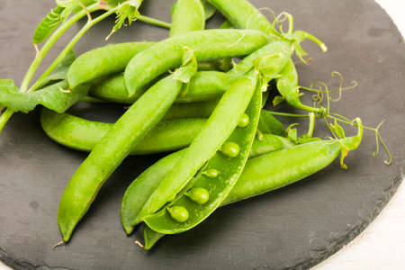 Ripe green peas with leavesの写真素材