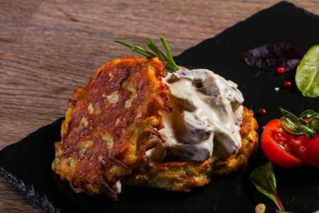 Potato cakes with meat served tomato