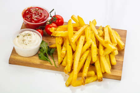 French potato with sauce over board