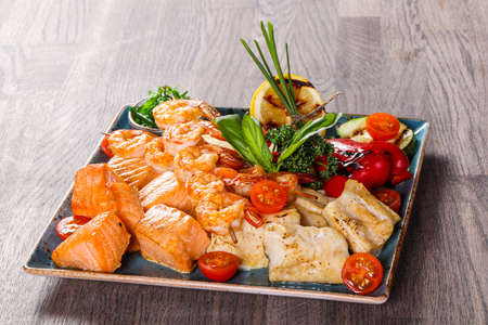 Fish and prawn plate served grilled vegetables