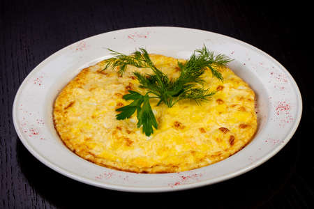 Delicious fried omelet with herbsの写真素材