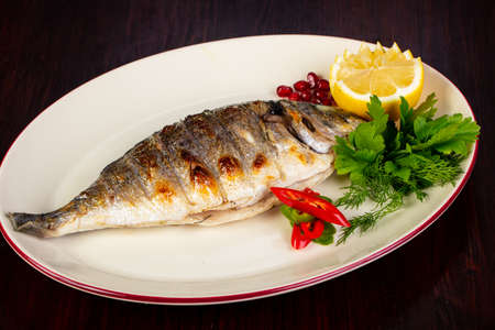 Grilled dorada served lemon and herbsの写真素材