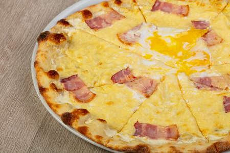 Pizza carbonara with bacon and eggの写真素材