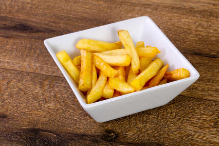 French fry potato over wooden backgroundの写真素材