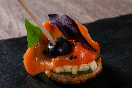 Canape with salmon and salad leaves
