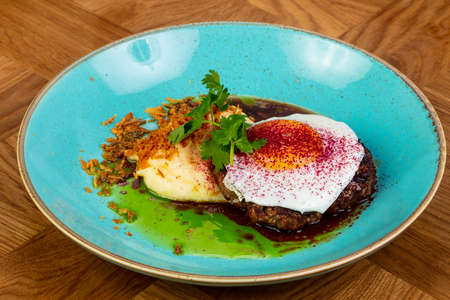 Roasted beefsteak with egg and mushed potato