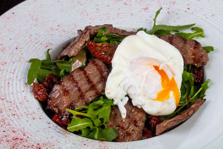 Tasty beef cut salad with poached eggの写真素材