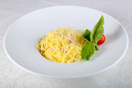 Pasta Carbonara served Basil leavesの写真素材