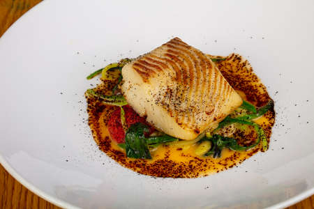 Roasted fish halibut with spicesの写真素材