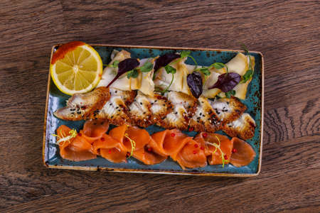 Sliced fish plate served lemonの写真素材