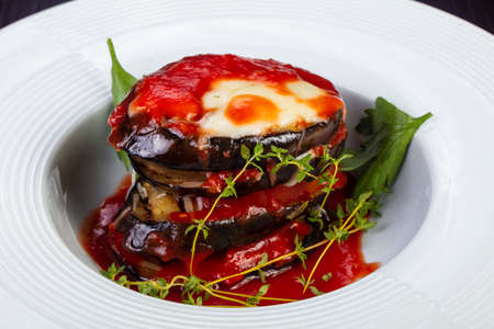 Appetizing eggplant parmigiano with  cheese and tomato sauce