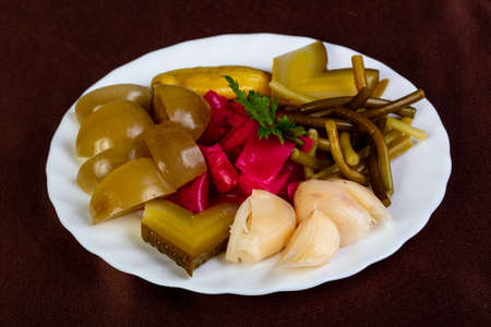 Pickled vegetables plate over the wooden backgroundの写真素材
