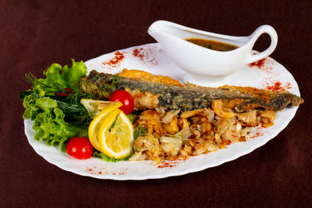 Roasted mullet fish with fried onion